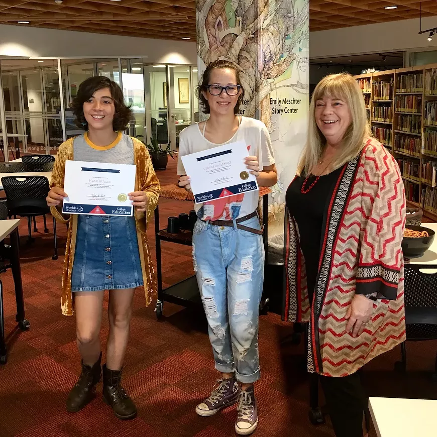 WOW Teen Reading Ambassadors receive certificates of completion from Dr. Kathy G. Short.