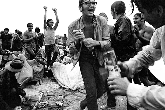 Rain did not dampen the spirits of these Woodstock attendees.