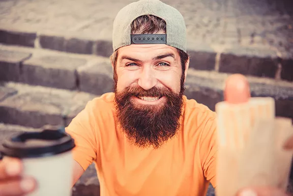 bigstock-man-bearded-eat-tasty-sausage--320820472.webp