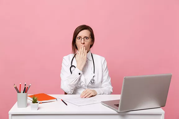 bigstock-tired-sad-female-doctor-sits-a-295727383.webp