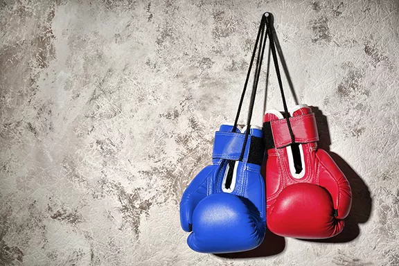 bigstock-red-and-blue-boxing-gloves-han-228079651.webp
