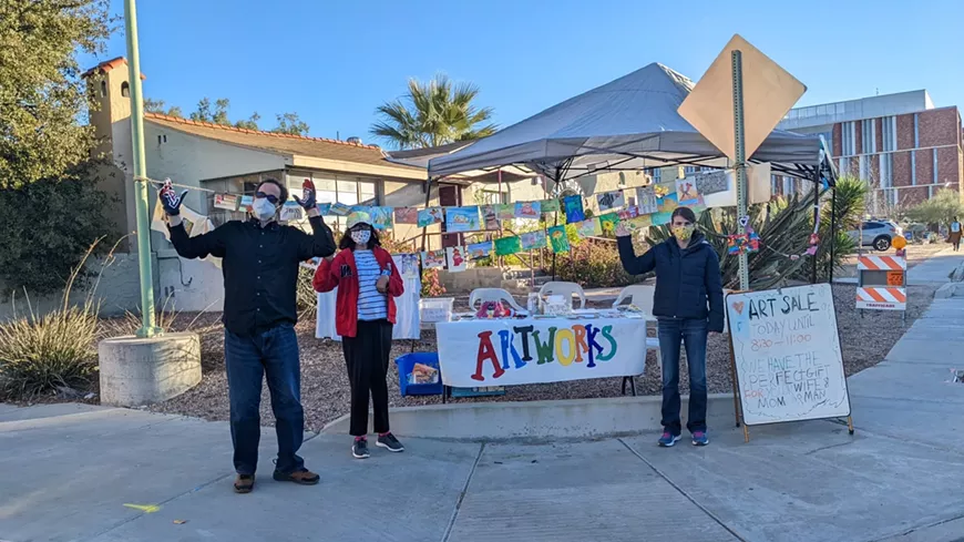 artworks artists in front of pop-up art sale